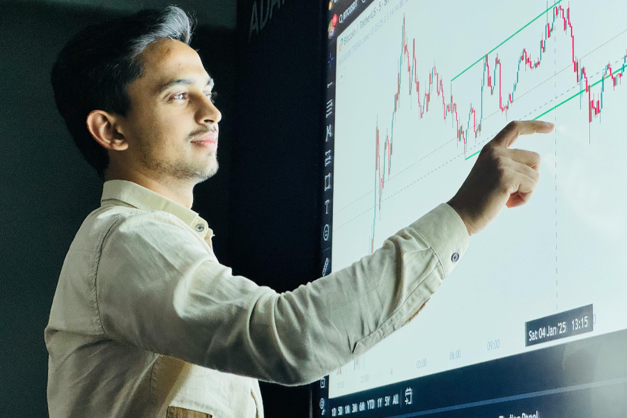 Instructor providing one-on-one guidance to a student in a small group setting, highlighting personalized support in training program