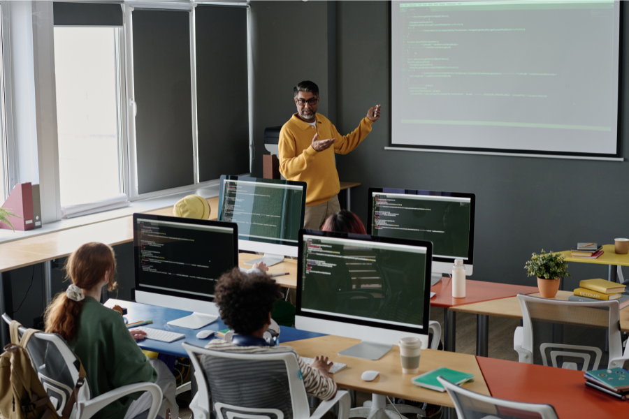 Student learning SQL and database programming on a laptop