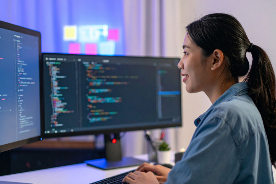 A young woman learning Android app development on her laptop during a training course